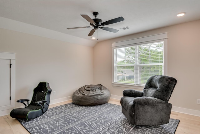 sitting room with baseboards, ceiling fan, wood finished floors, and visible vents