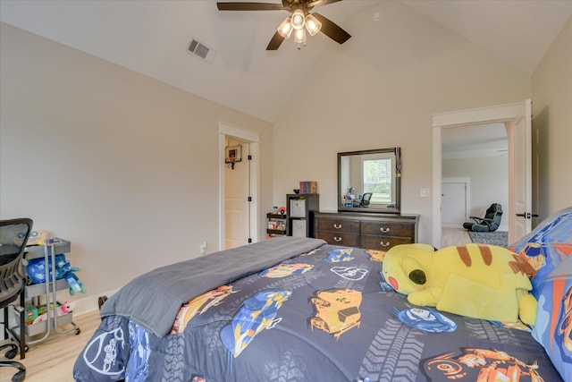 bedroom with high vaulted ceiling, a ceiling fan, wood finished floors, and visible vents