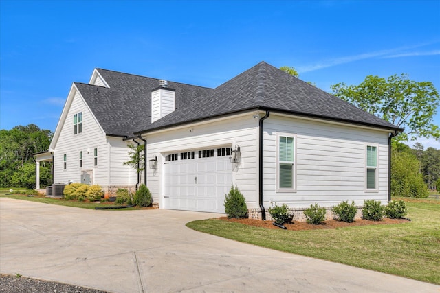 view of home's exterior with concrete driveway, a chimney, roof with shingles, and a garage