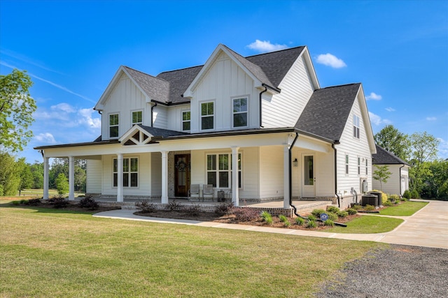 modern inspired farmhouse with covered porch, board and batten siding, and cooling unit