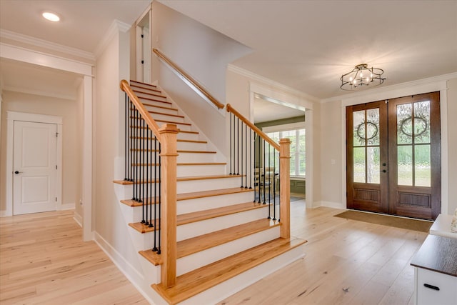 foyer with stairs, french doors, and light wood-type flooring