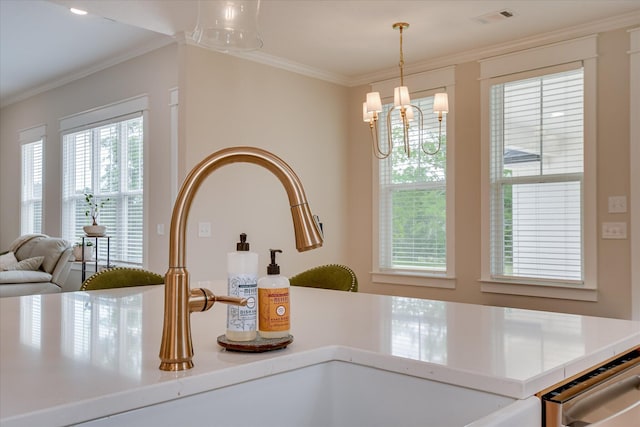 details with a chandelier, visible vents, ornamental molding, and a sink