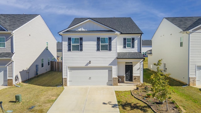 view of front of home featuring a garage and a front yard