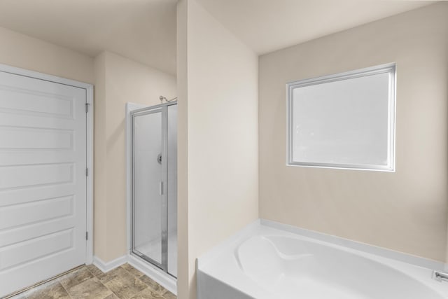 bathroom with shower with separate bathtub