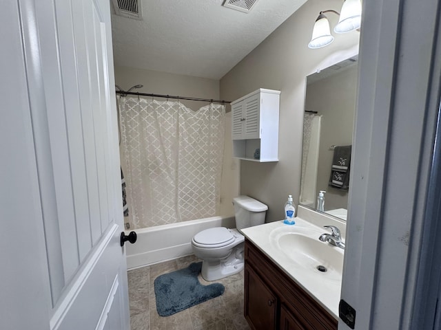 full bathroom with vanity, shower / tub combo, toilet, and a textured ceiling