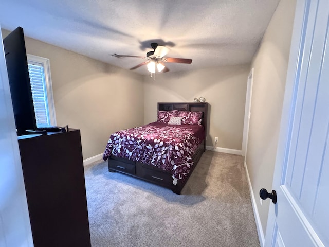 bedroom with carpet floors, baseboards, a ceiling fan, and a textured ceiling