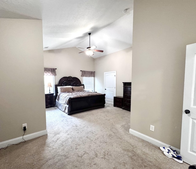 carpeted bedroom featuring baseboards, a ceiling fan, and high vaulted ceiling