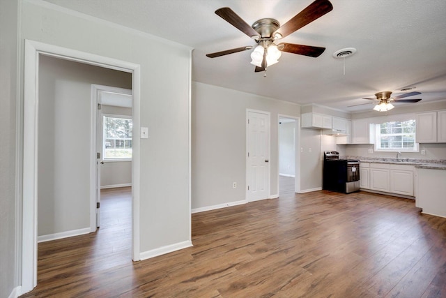 3204 Hillis Rd, Augusta, GA 30906 - kitchen featuring stainless steel stove, ceiling fan, white cabinets, and wood finished floors