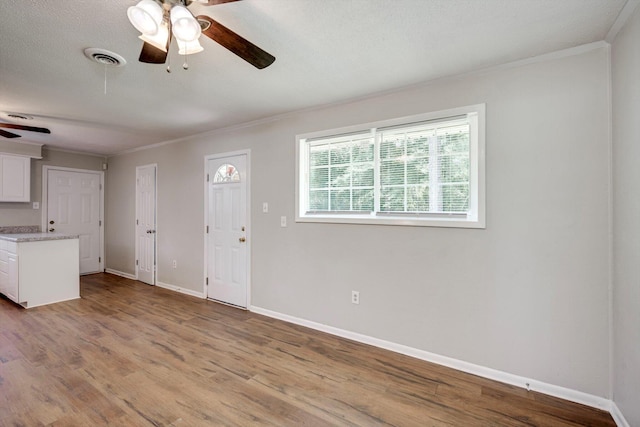 3204 Hillis Rd, Augusta, GA 30906 - unfurnished living room with ceiling fan, crown molding, and wood finished floors