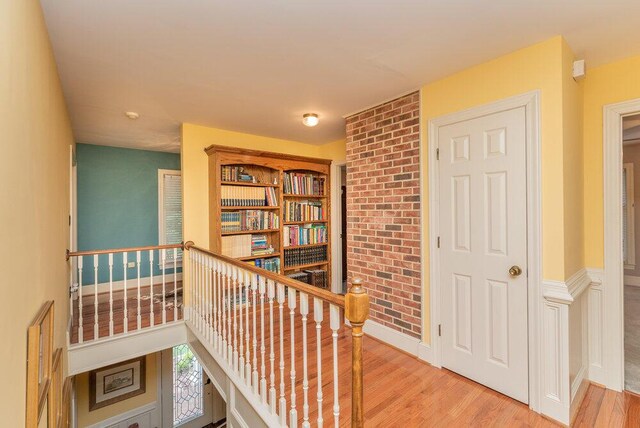 3287 Surrey Rd, Thomson, GA 30824 - hallway with brick wall and wood finished floors