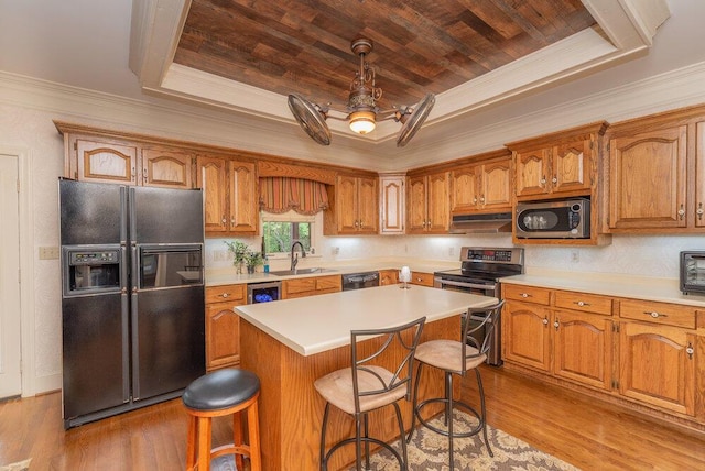 3287 Surrey Rd, Thomson, GA 30824 - kitchen featuring wood finished floors, a sink, wooden ceiling, black appliances, and a tray ceiling