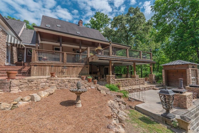 3287 Surrey Rd, Thomson, GA 30824 - back of house featuring a shingled roof, a patio area, a wooden deck, and a chimney