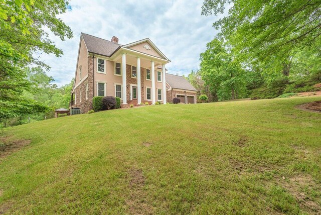3287 Surrey Rd, Thomson, GA 30824 - neoclassical / greek revival house featuring a chimney, an attached garage, and a front yard