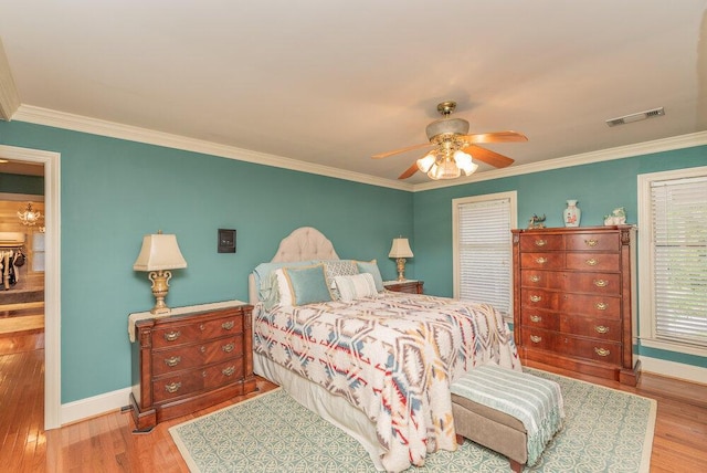 3287 Surrey Rd, Thomson, GA 30824 - bedroom with baseboards, visible vents, ornamental molding, and wood finished floors