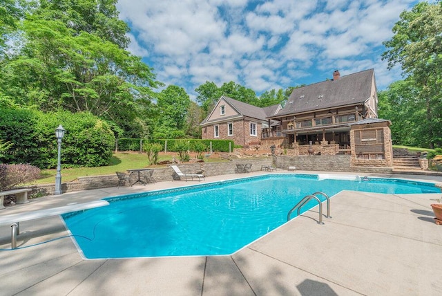 3287 Surrey Rd, Thomson, GA 30824 - outdoor pool featuring fence, a diving board, and a patio area