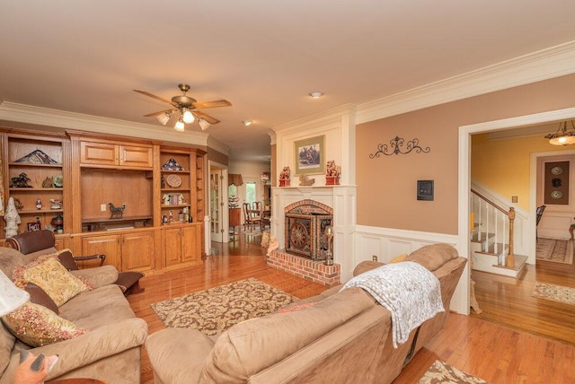 3287 Surrey Rd, Thomson, GA 30824 - living room featuring crown molding, a ceiling fan, stairway, and light wood-type flooring
