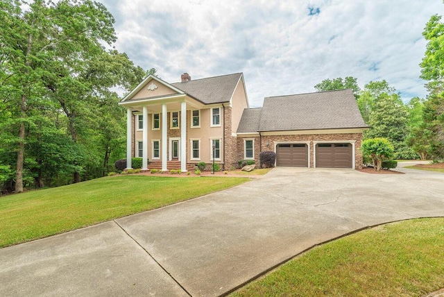 3287 Surrey Rd, Thomson, GA 30824 - greek revival house with a shingled roof, an attached garage, a front lawn, a chimney, and concrete driveway