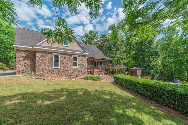 3287 Surrey Rd, Thomson, GA 30824 - back of house featuring a wooden deck, a chimney, a yard, and stone siding