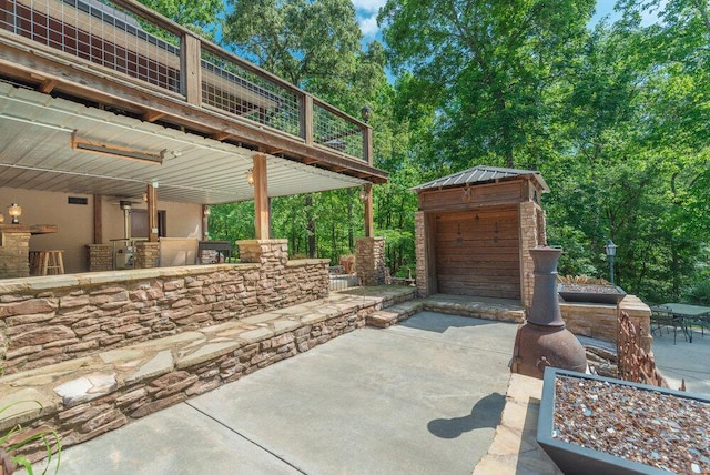 3287 Surrey Rd, Thomson, GA 30824 - view of patio with concrete driveway, an outbuilding, and a detached garage