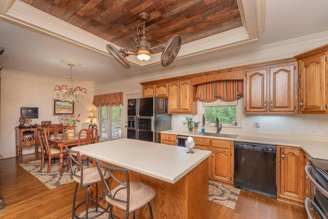 3287 Surrey Rd, Thomson, GA 30824 - kitchen with a kitchen breakfast bar, light wood-type flooring, a sink, black appliances, and a chandelier