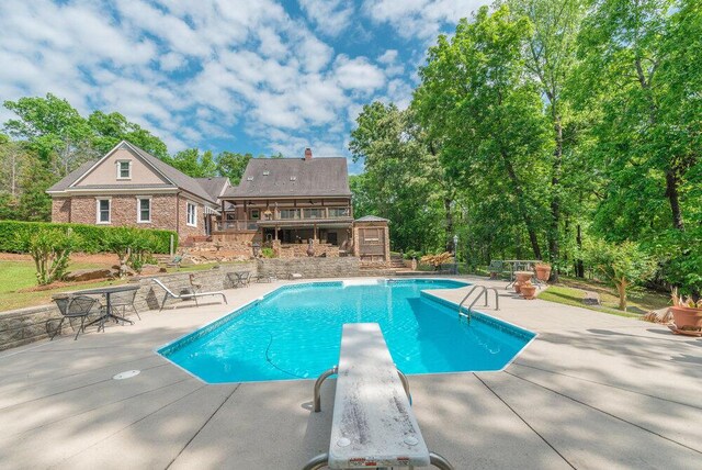 3287 Surrey Rd, Thomson, GA 30824 - outdoor pool featuring a patio, a diving board, and a wooden deck