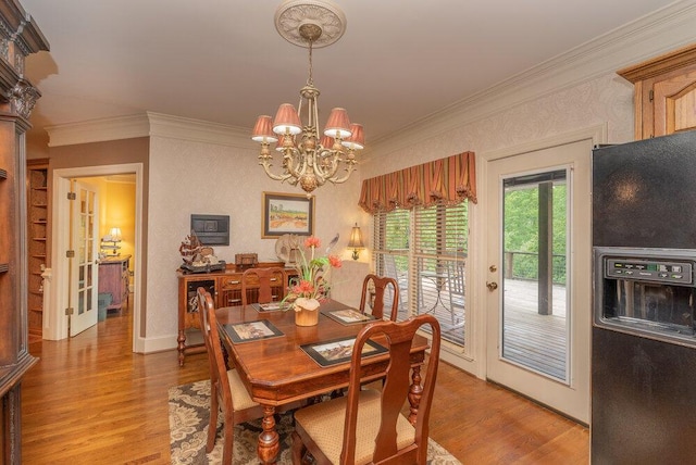 3287 Surrey Rd, Thomson, GA 30824 - dining room with crown molding, light wood-style flooring, and a chandelier