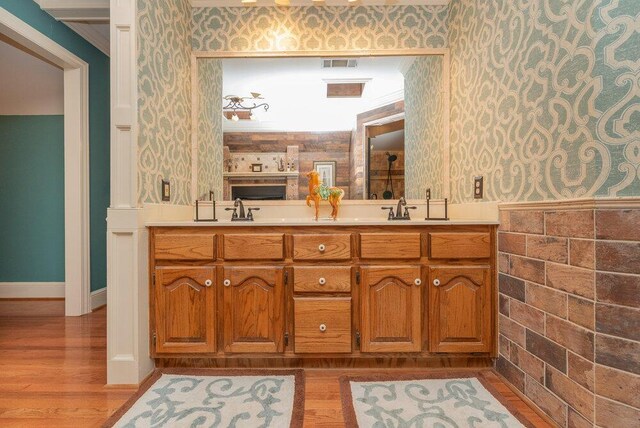 3287 Surrey Rd, Thomson, GA 30824 - full bath with visible vents, wood finished floors, and wallpapered walls