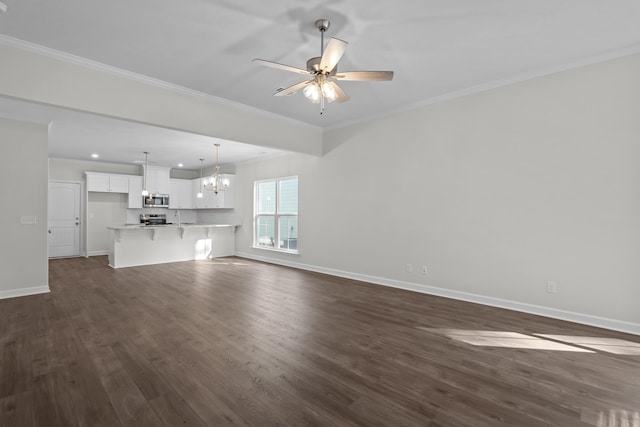 unfurnished living room featuring ornamental molding, ceiling fan with notable chandelier, and dark hardwood / wood-style flooring