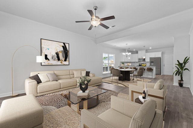 living room with ornamental molding, hardwood / wood-style floors, and ceiling fan with notable chandelier