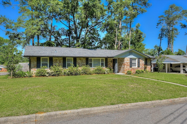 ranch-style house with a front yard, brick siding, and a carport