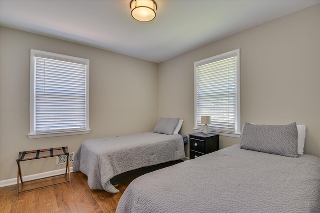 bedroom with wood finished floors and baseboards