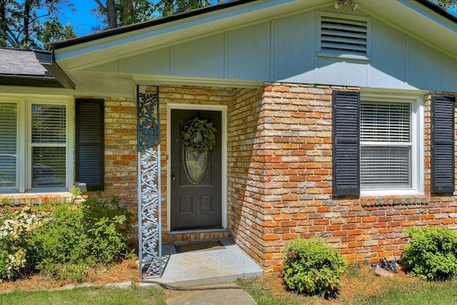 entrance to property with brick siding and board and batten siding
