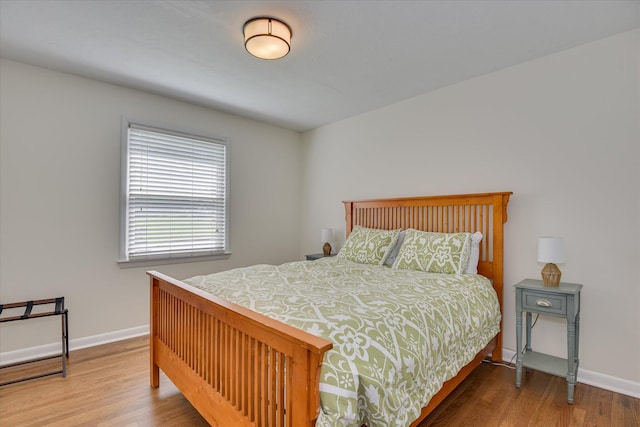 bedroom featuring wood finished floors and baseboards