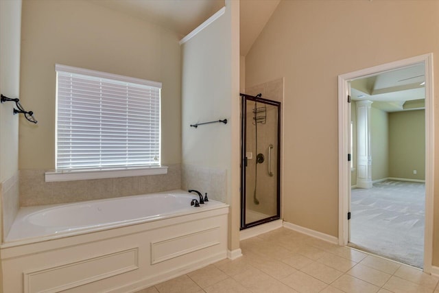 bathroom with tile patterned flooring, ornate columns, shower with separate bathtub, and vaulted ceiling