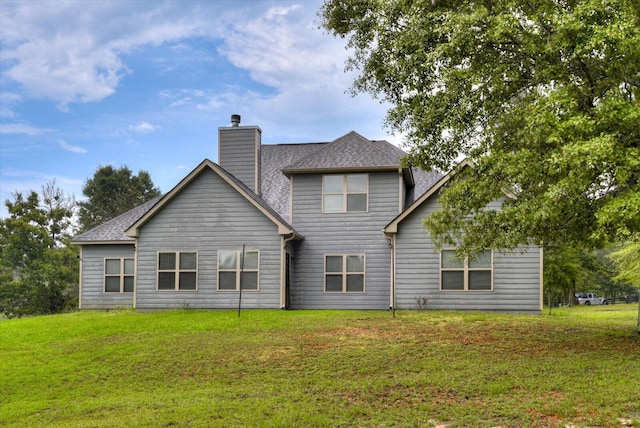 back of property featuring a yard