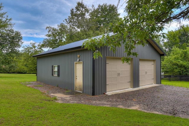 garage featuring a lawn