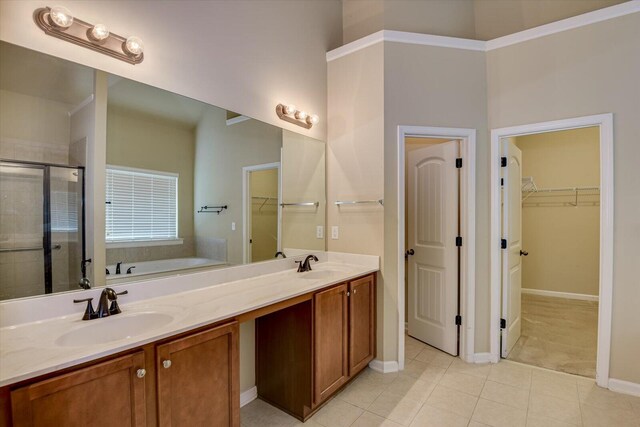 bathroom with vanity, tile patterned flooring, and plus walk in shower