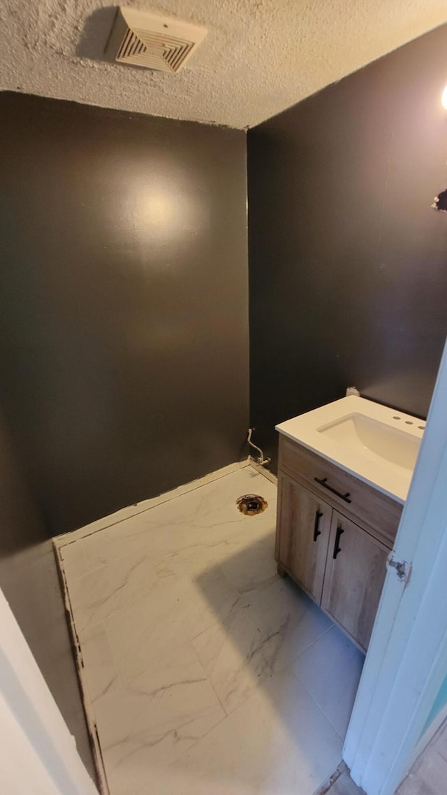 bathroom with vanity and a textured ceiling