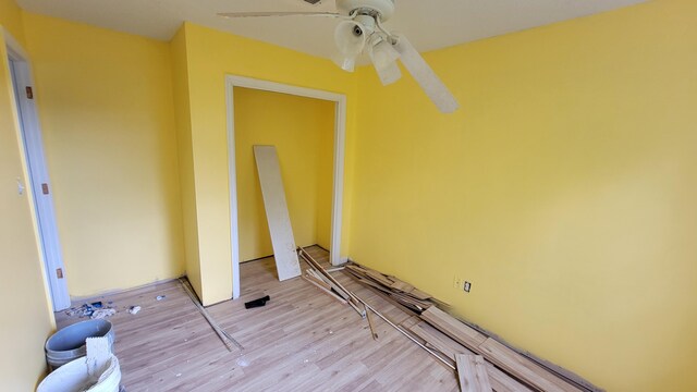 spare room with light hardwood / wood-style flooring and ceiling fan