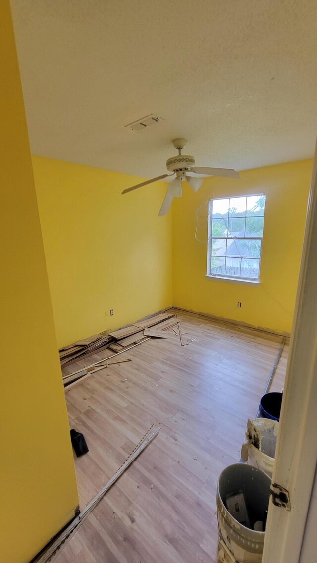 empty room featuring ceiling fan and light wood-type flooring