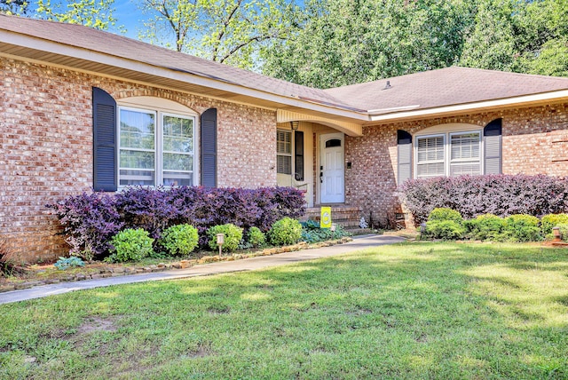 2530 Springwood Dr, Augusta, GA 30904 - view of exterior entry with brick siding and a yard