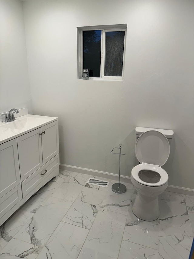 bathroom featuring vanity and toilet