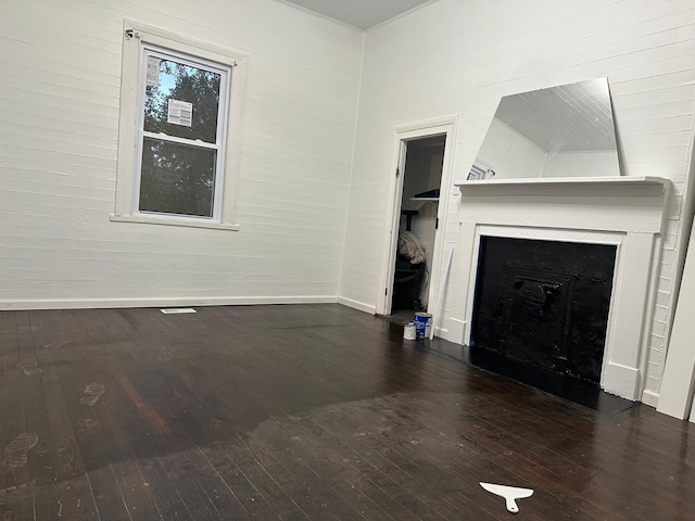 unfurnished living room featuring dark wood-type flooring