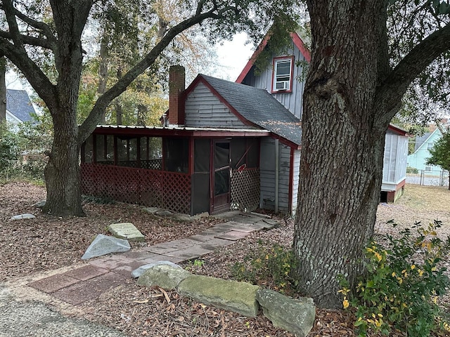 view of front of house with a sunroom and cooling unit