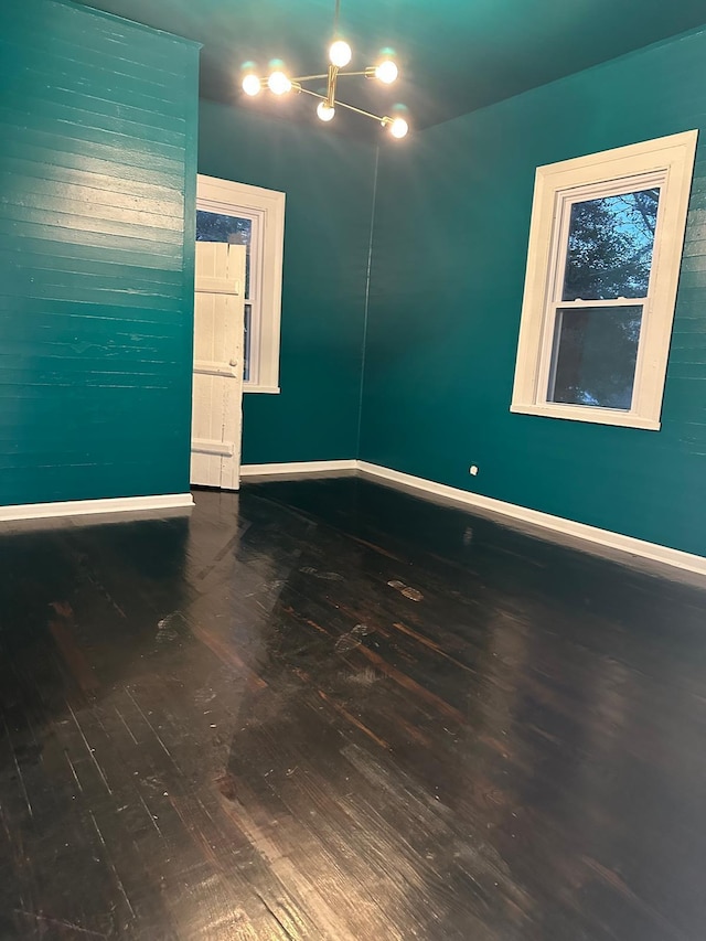 unfurnished room with hardwood / wood-style flooring