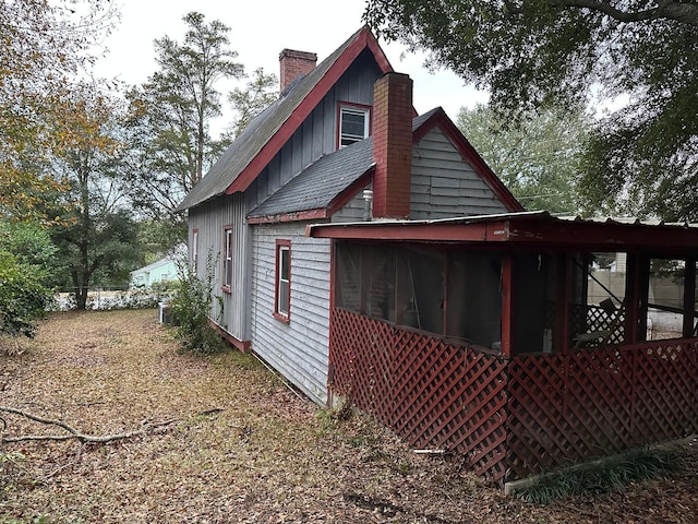 view of side of property featuring a sunroom