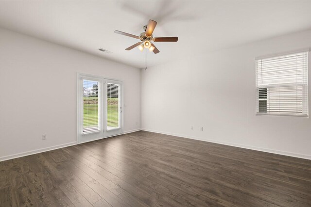 spare room featuring ceiling fan and dark hardwood / wood-style flooring