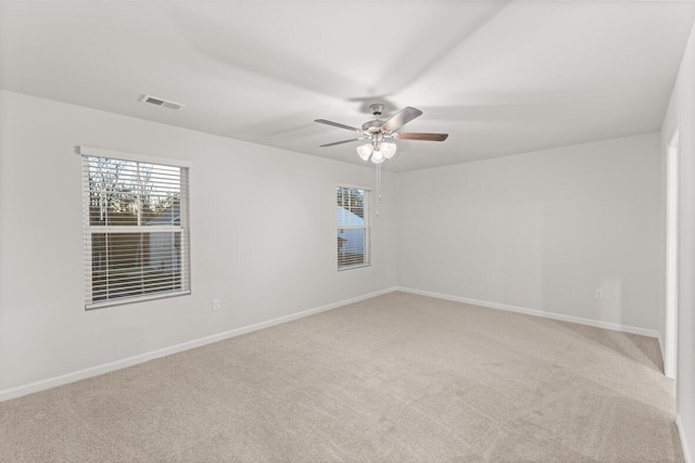 carpeted spare room featuring ceiling fan