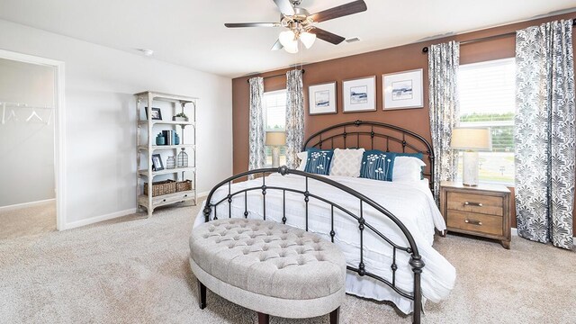 carpeted bedroom featuring ceiling fan and a closet