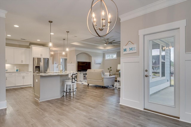 248 Amelia Dr, Mccormick, SC 29835 - kitchen with stainless steel fridge with ice dispenser, open floor plan, white cabinets, and ornamental molding